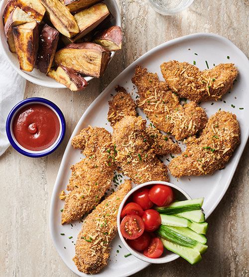 Baked cheesy crumbed chicken with kūmara chips