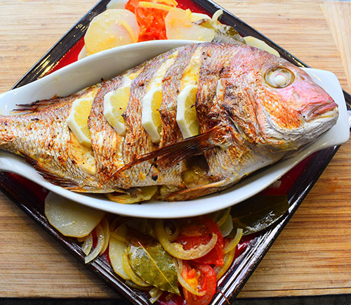 Whole baked Leigh snapper on potato