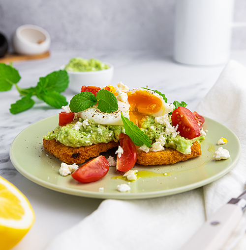 Smashed avocado and poached eggs on hash browns