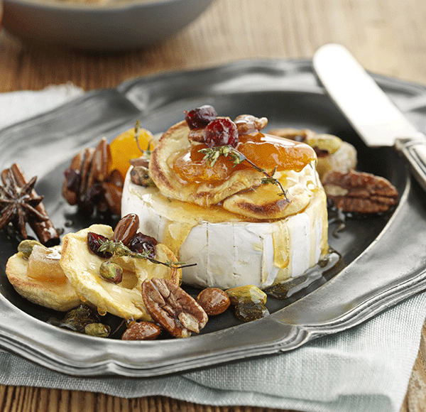 Decadent baked Brie topped with honey fruit and nuts